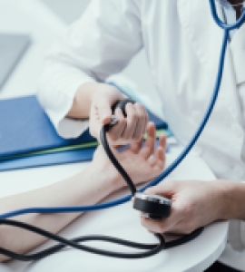 Doctor taking and employee's blood pressure