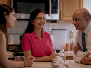 family sitting in kitchen talking