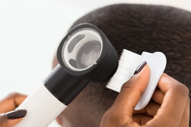 Dermatologist checking a patient's hair