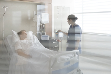 nurse talking to patient in hospital bed