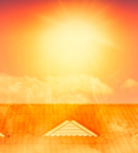 Bright orange sun over rooftop	