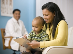 Mom and child with doctor looking on