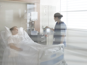 nurse talking to patient in hospital bed