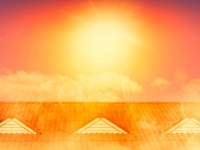 Bright orange sun over rooftop	