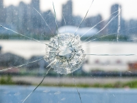 Pane of glass with bullet hole in it